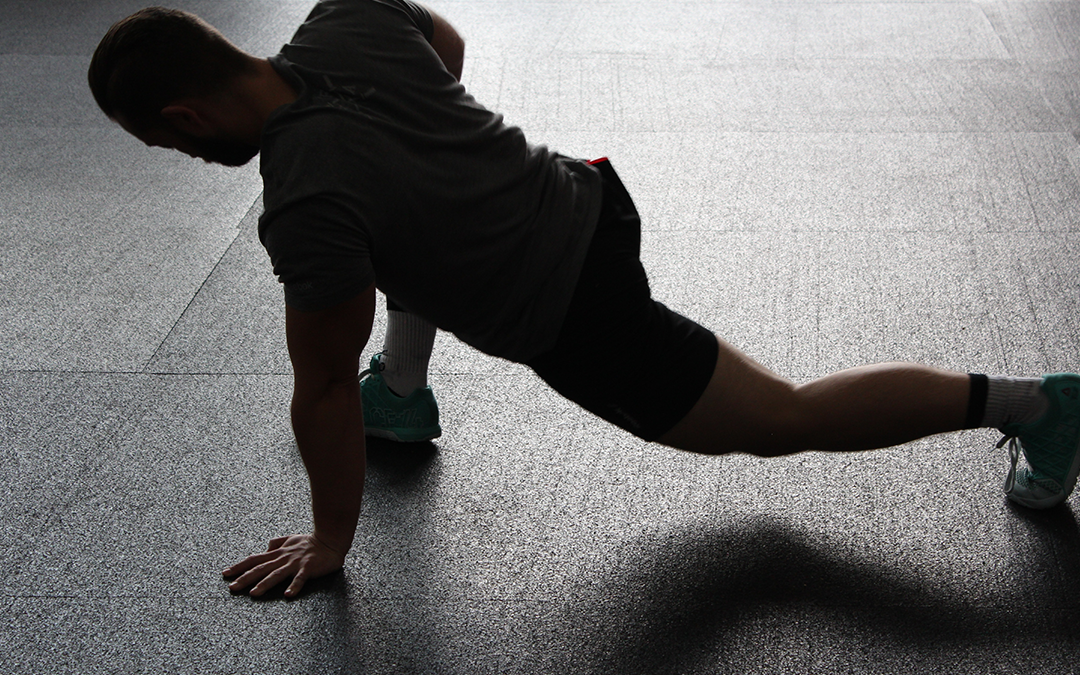 5 steps to looking 10 years younger, Handsome man stretching on ground