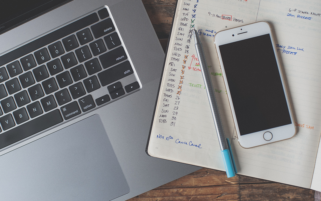 One Week Stress Management Plan, image of a computer and a planner sitting on a desk with a pen