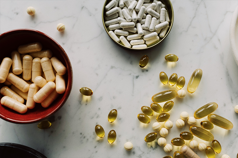 Best Anti-Aging Supplements For Men, image of supplements on a table spread out